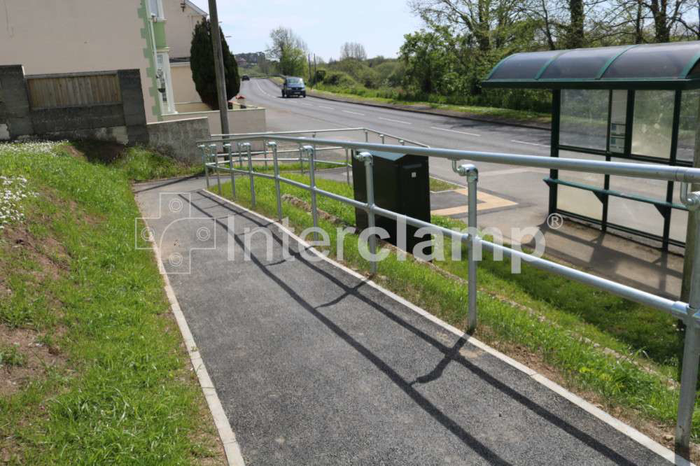 Interclamp modular disability handrail on pedestrian access ramp